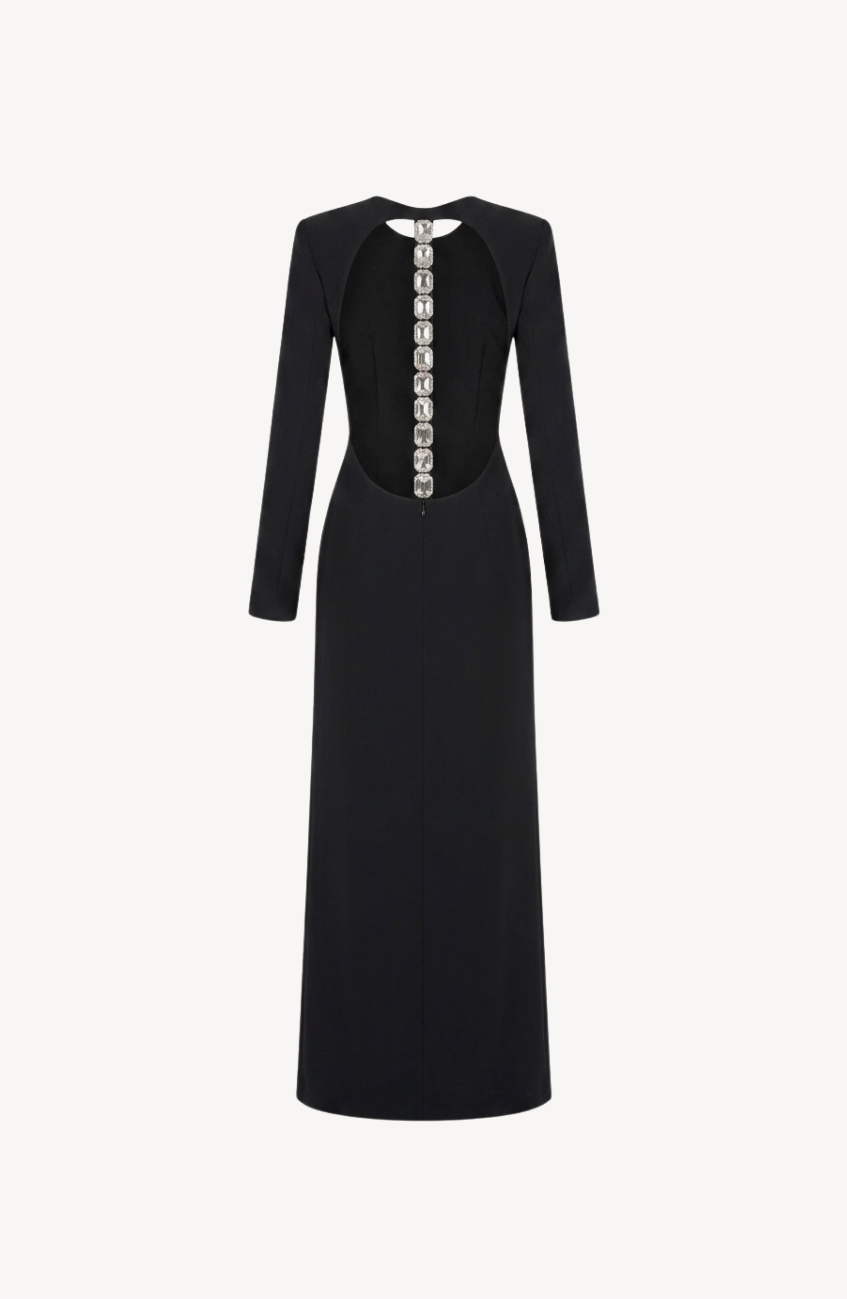 The LOULOU Back Crepe Maxi Dress is a long-sleeved black crepe gown with a fitted waist and a floor-length skirt. It showcases elegant, large round decorative buttons running down the back, while an open back detail lends a modern twist to its timeless silhouette. The dress is shown against a plain white background.