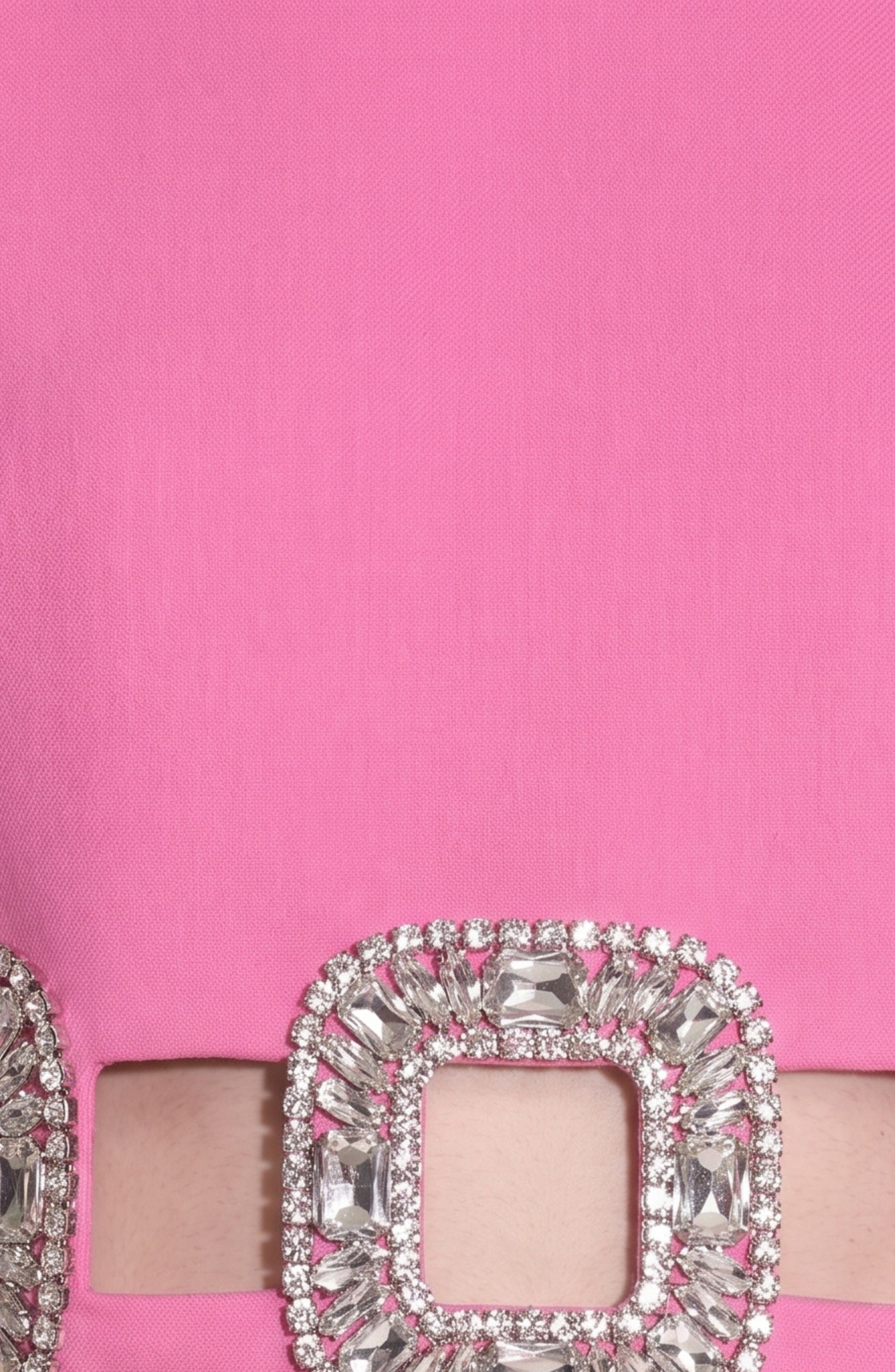 A close-up of the LOULOU Crystal Buckle Cut-Out Top showcases its pink fabric belt with a crystal-embellished square buckle adorned with sparkling clear gemstones, designed to accentuate the waist cut-out detail.