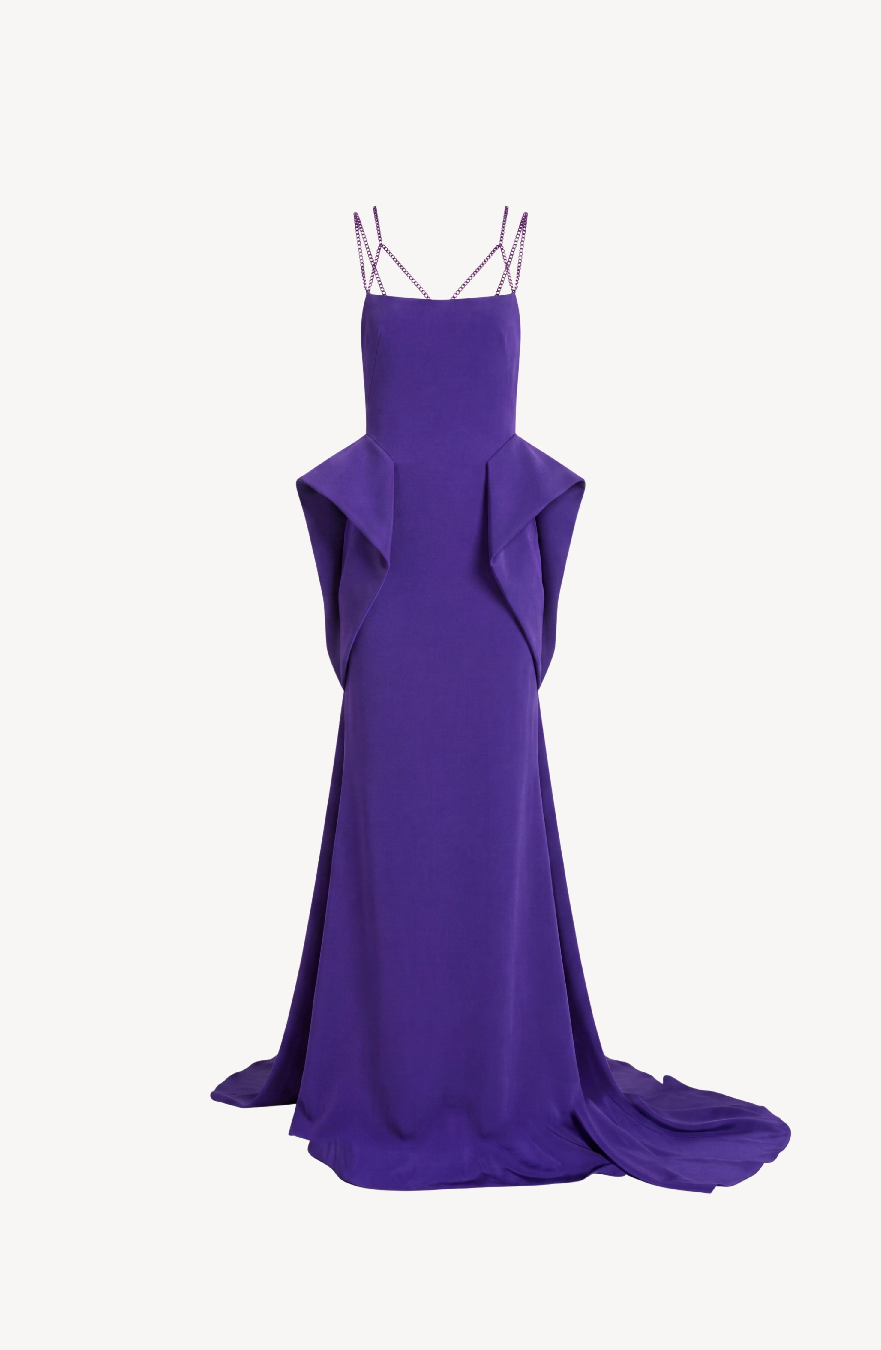 The LOULOU Crystal Strap Peplum Gown is a floor-length, sleeveless purple evening gown featuring crystal chain straps, geometric side panels, and a slight train, displayed on a white background.
