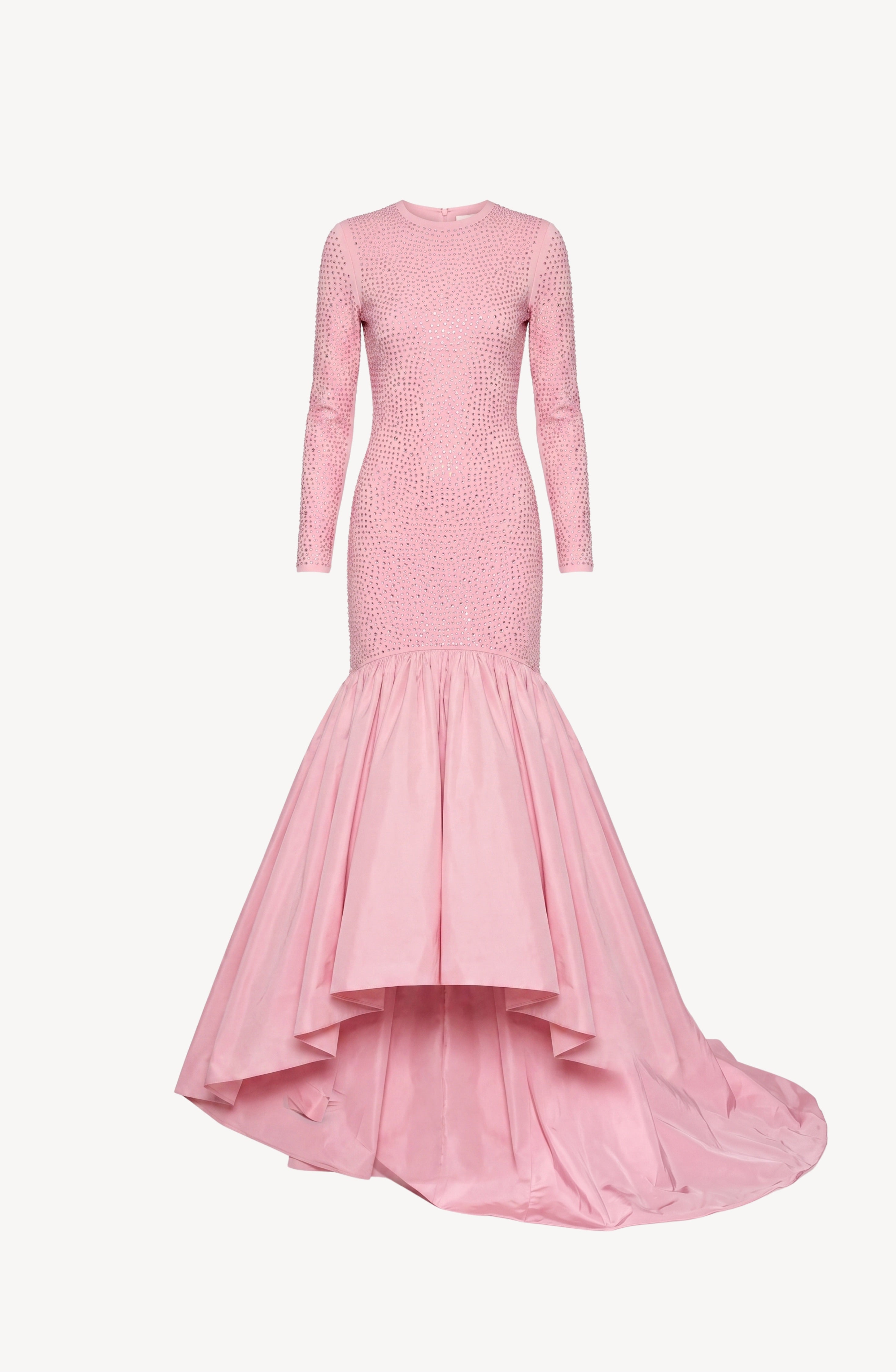 The Embellished Taffeta Gown by LOULOU features long sleeves, a light pink hue, a fitted bodice with crystal embellishments, and a dramatic flared high-low taffeta skirt, showcased against a plain white background.