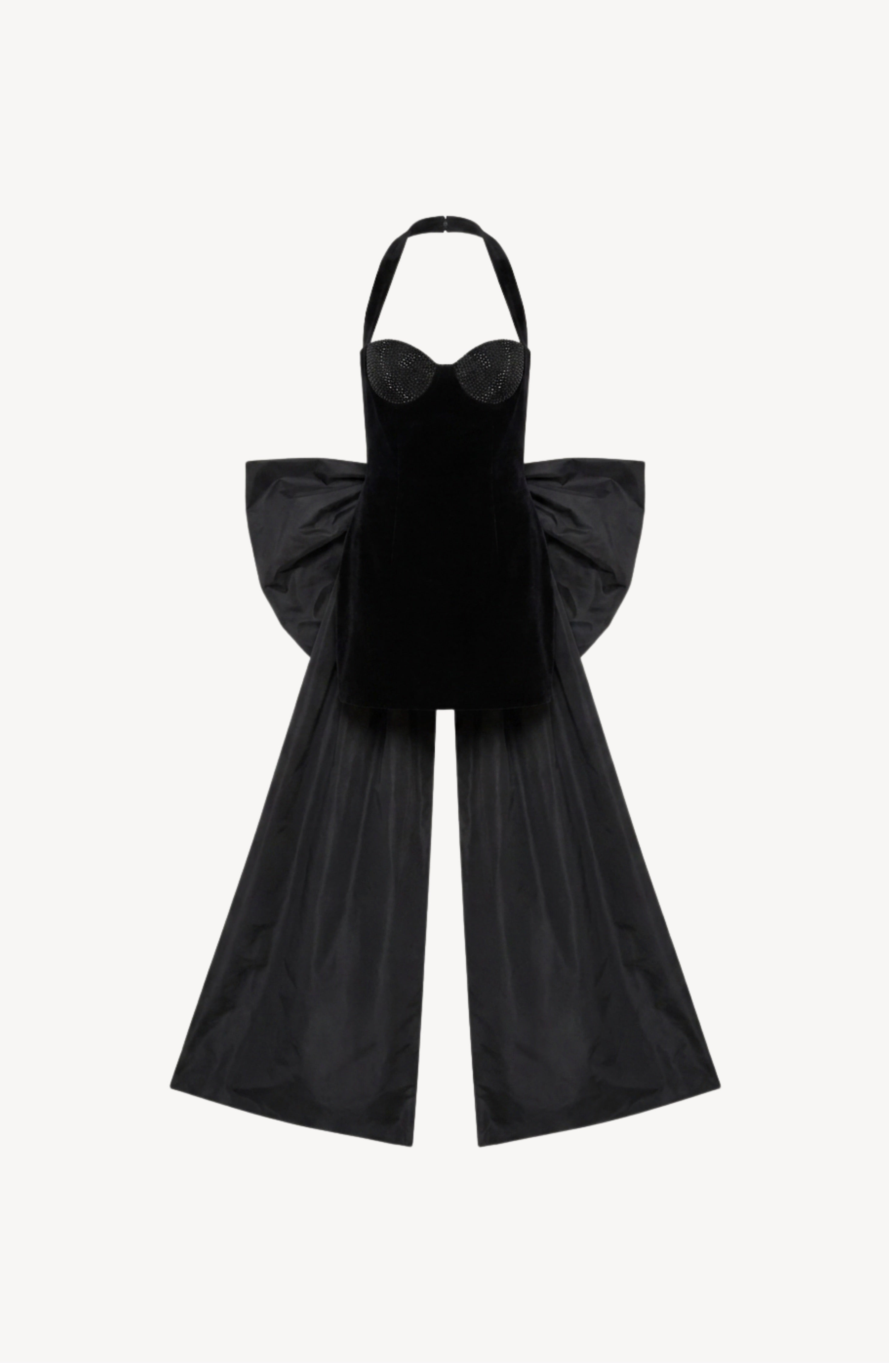 A black velvet halter bow mini dress by LOULOU, featuring a fitted bodice, dramatic flared skirt, and large structured side panels reminiscent of wings or a cape, evokes bold sophistication and is displayed on a plain white background.