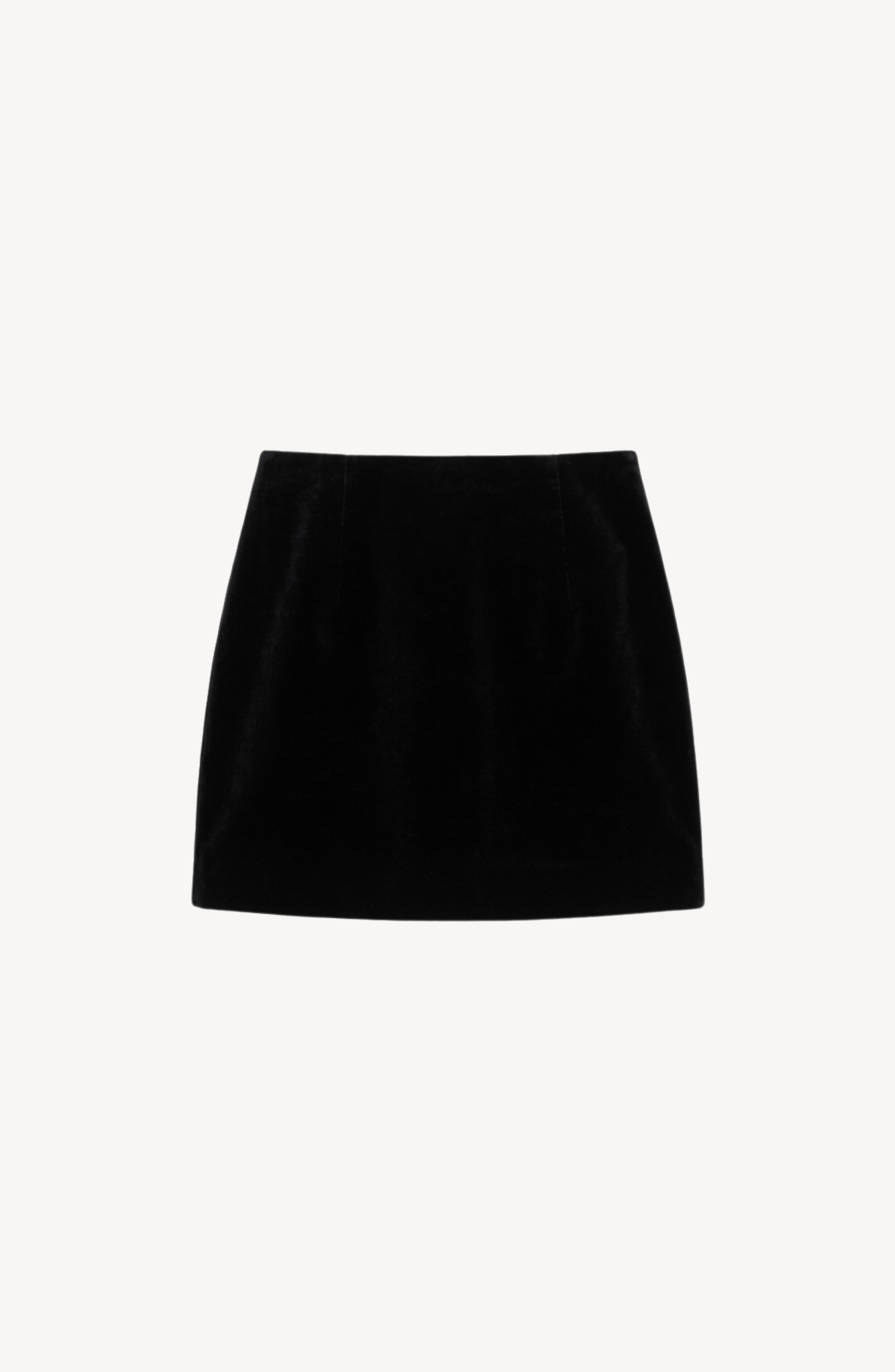 The LOULOU Velvet Mini Skirt is displayed against a white background, highlighting its sleek black velvet fabric and timeless elegance. This high-waisted skirt features a minimalist design, making it a versatile addition to any wardrobe.