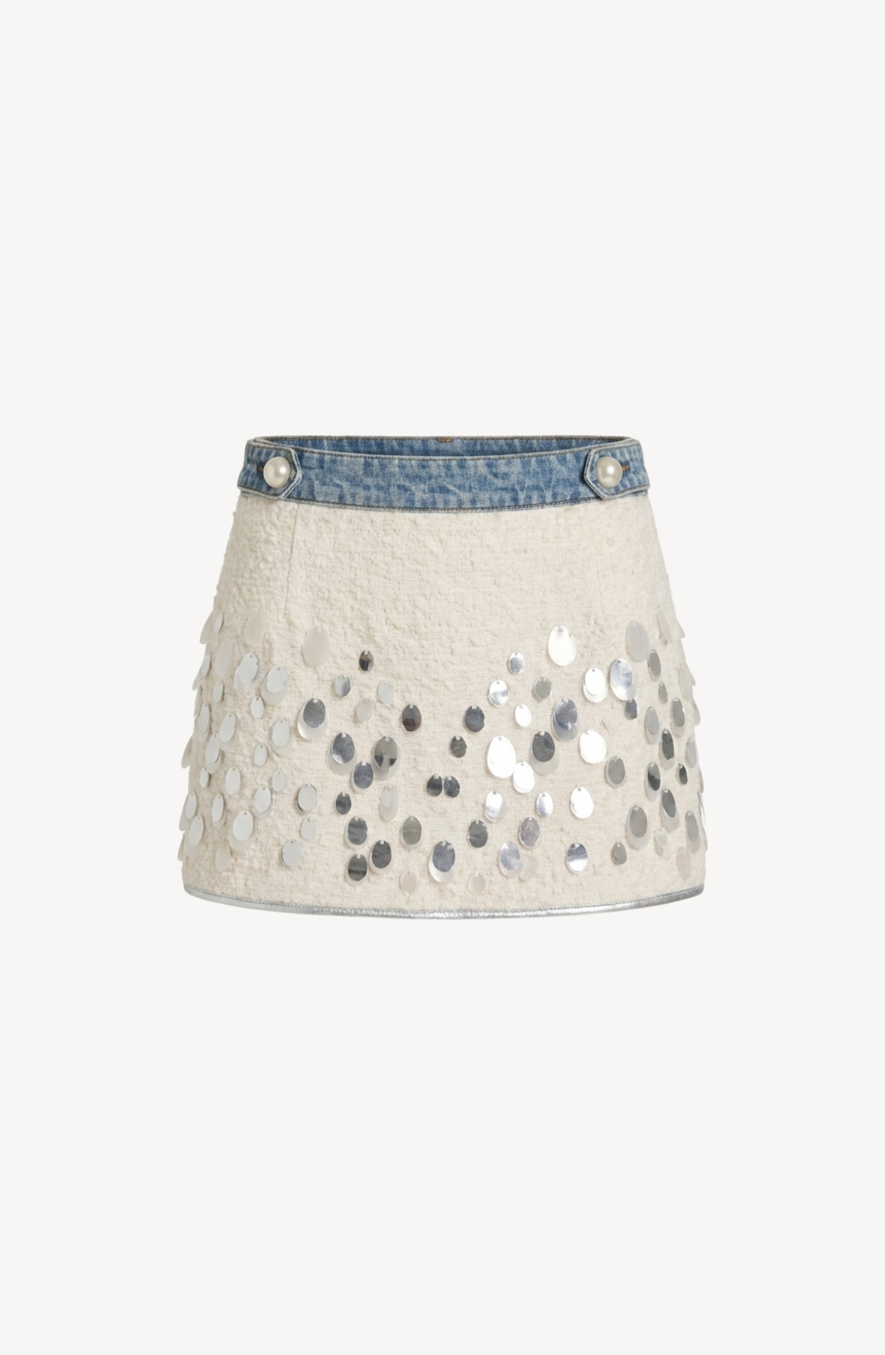 LOULOU’s Embellished Bouclé Mini Skirt showcases a blue denim waistband atop white textured bouclé fabric, accented with shimmering silver paillettes arrayed across the lower half.