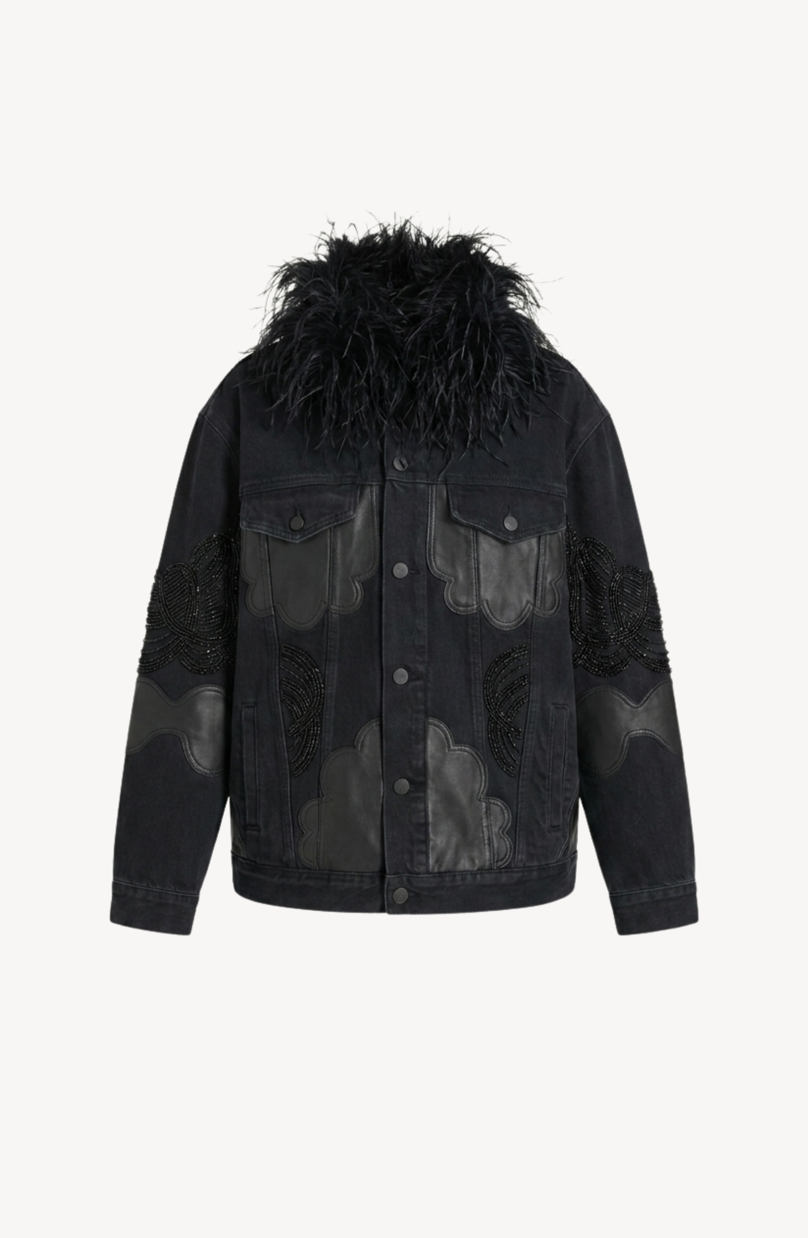 The LOULOU Feather-Trimmed Appliqué Denim Jacket is a black oversized piece featuring leather cloud-shaped appliqué patches, decorative beaded sleeve details, and a large, fluffy faux fur collar, shown against a plain white background.
