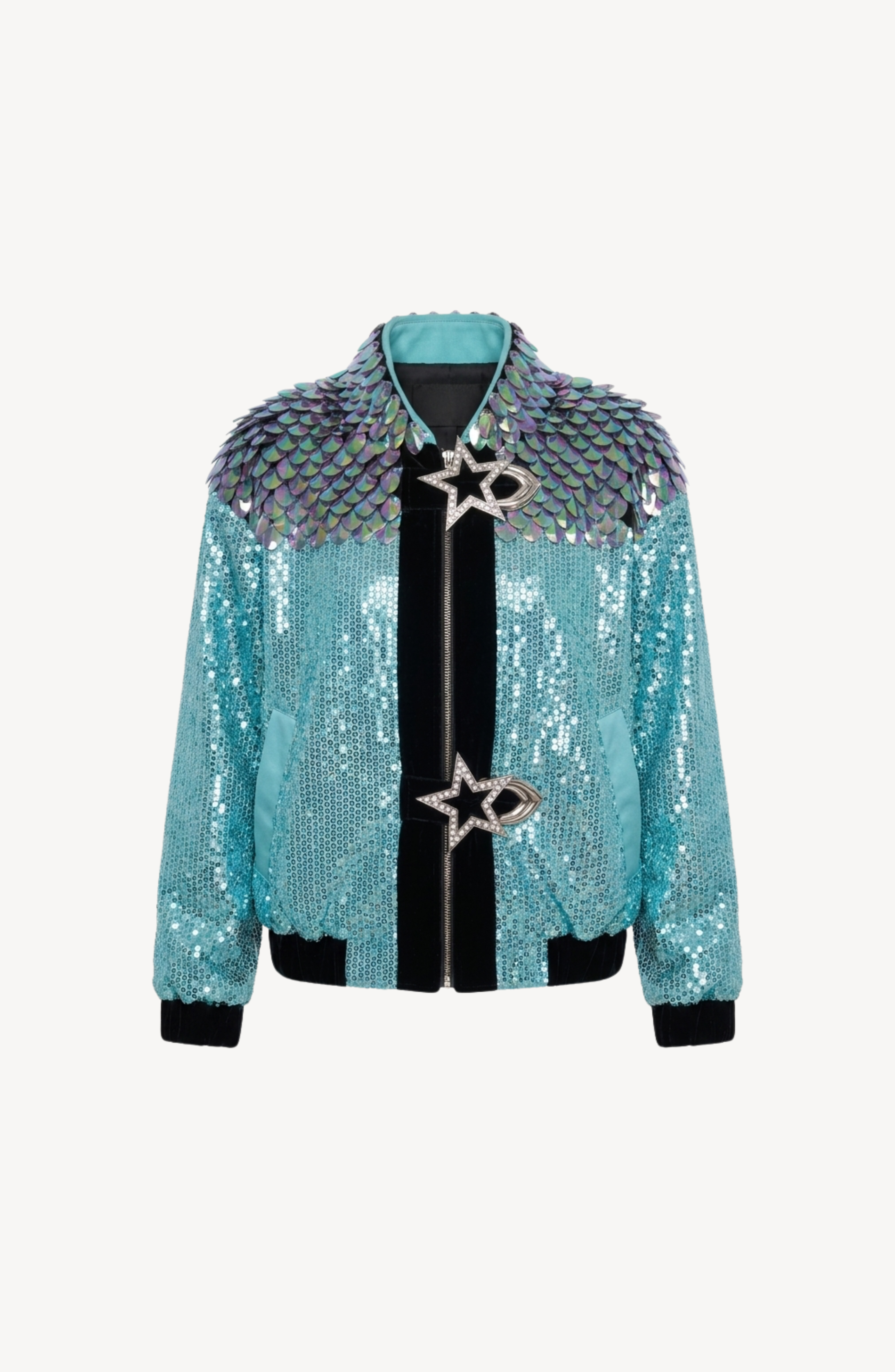 The LOULOU Sequin Star Buckle Bomber Jacket, featuring turquoise sequins, iridescent scale-like shoulder panels, and two oversized crystal star buckles on the front, is displayed against a plain white background.