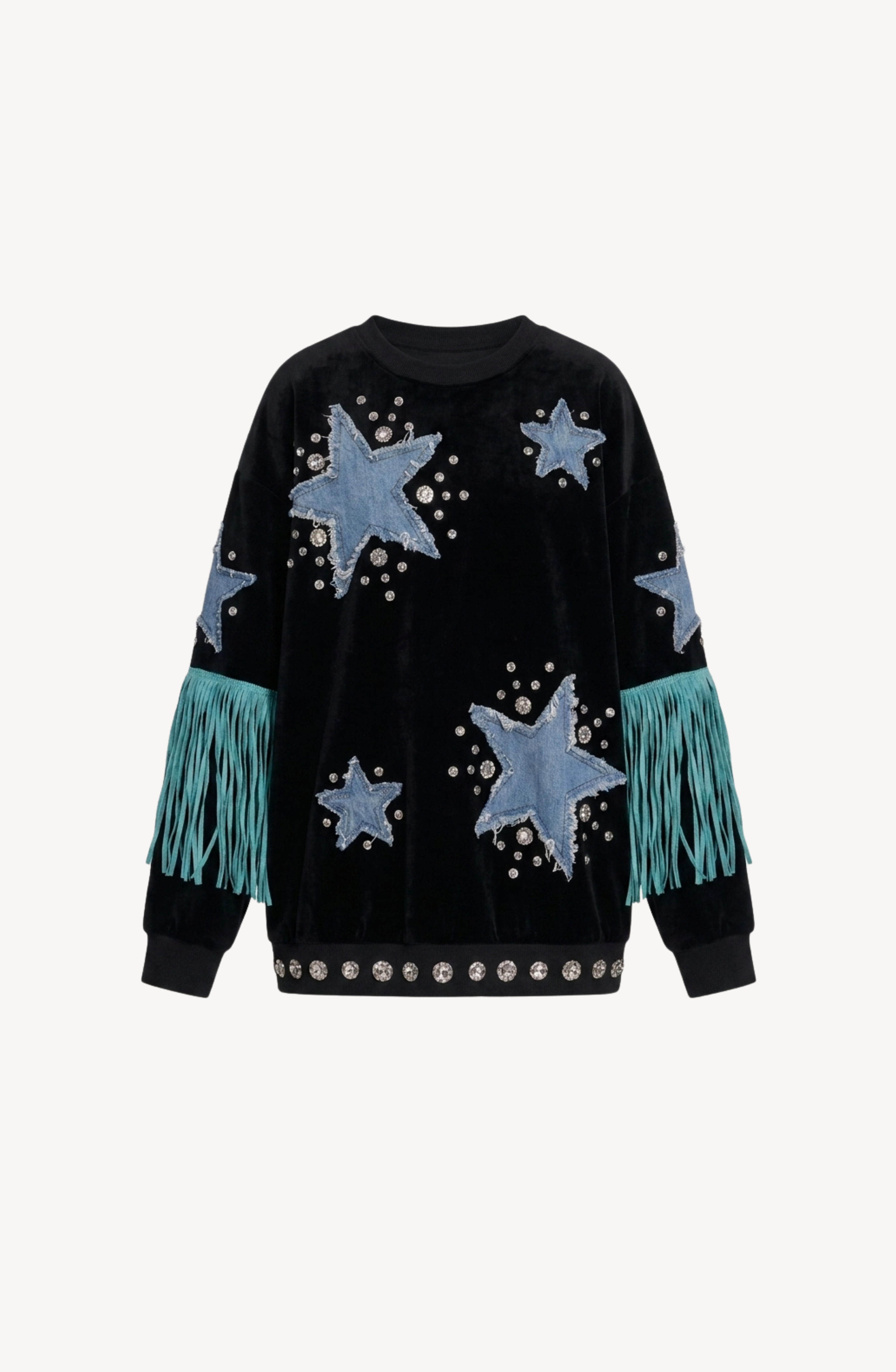 LOULOU Star Appliqué Velvet Sweatshirt in black, featuring blue denim star appliqués, silver studs, and turquoise fringe accenting the sleeves. The hem is adorned with a row of crystal embellishments. Displayed against a plain white background.