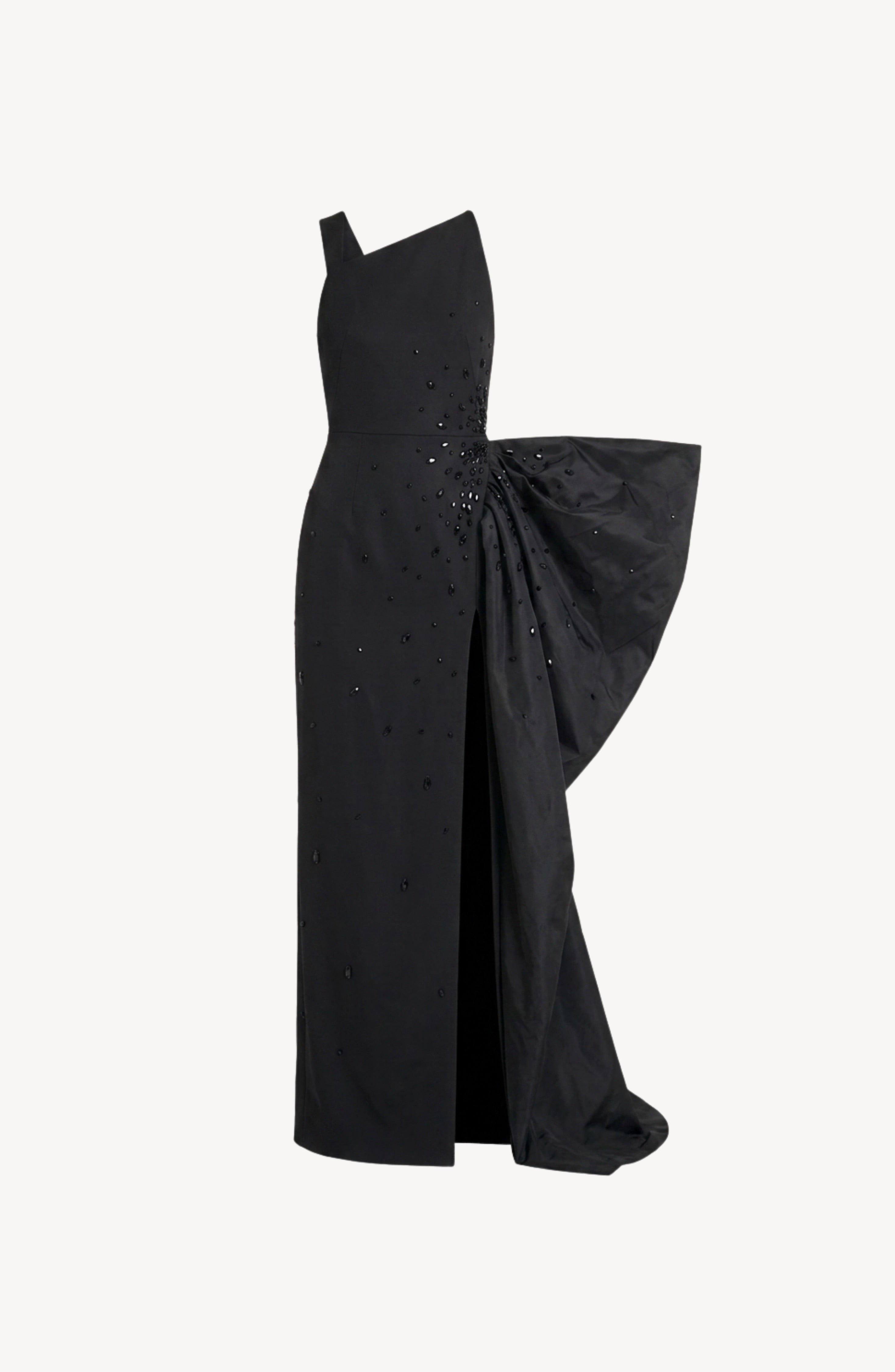 The LOULOU Asymmetric Crystal Bow Gown is a jet black dress showcasing an asymmetric one-shoulder neckline, a fitted bodice with scattered crystal embellishments, a striking side bow detail, and a front slit. This gown is displayed against a plain white background.