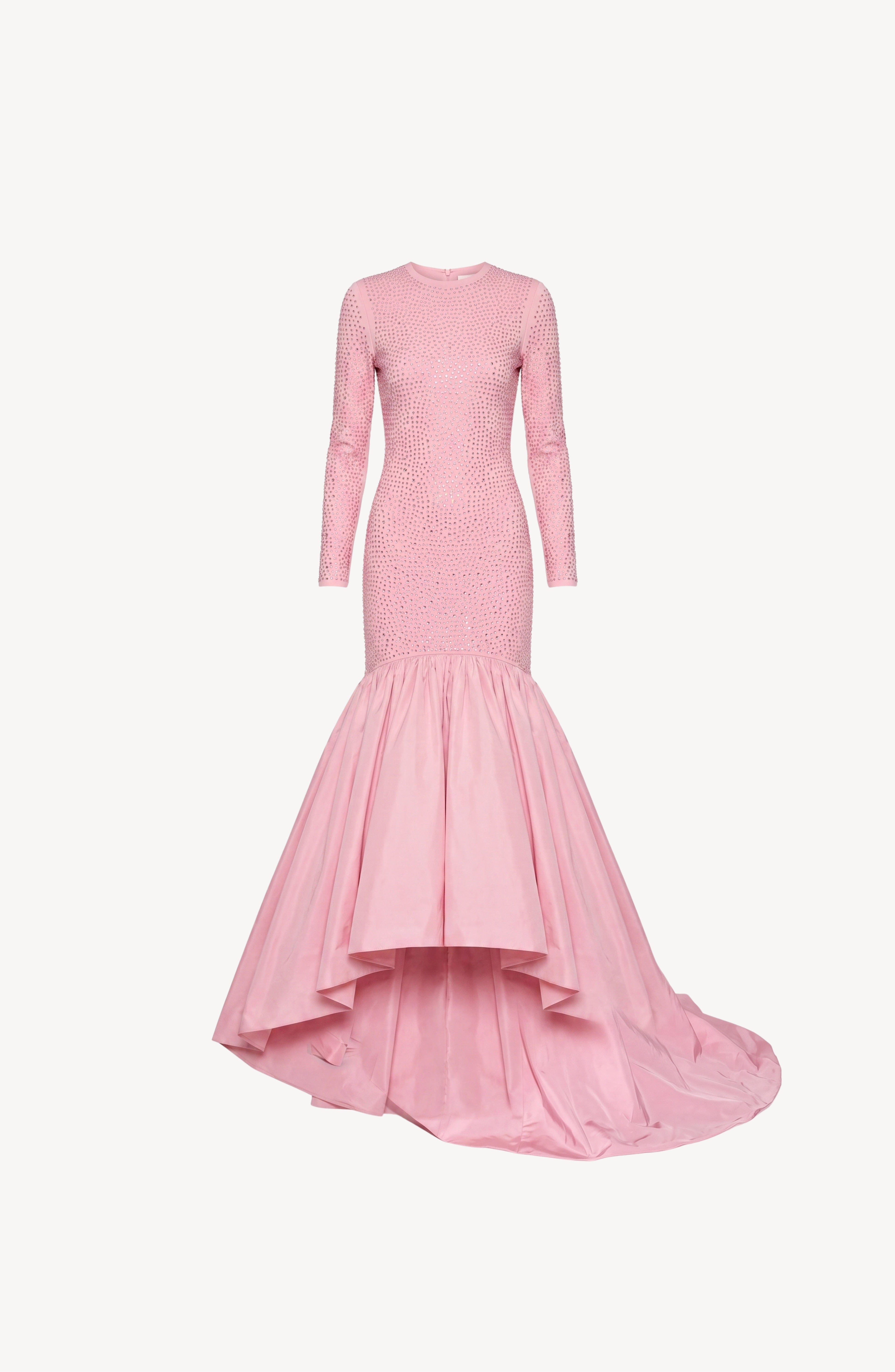The LOULOU Crystal Embellished High-Low Gown is a long-sleeved, fitted rose pink dress featuring a crystal-embellished bodice and sparkling details, finished with a dramatic flared high-low taffeta skirt and train, displayed against a plain white background.