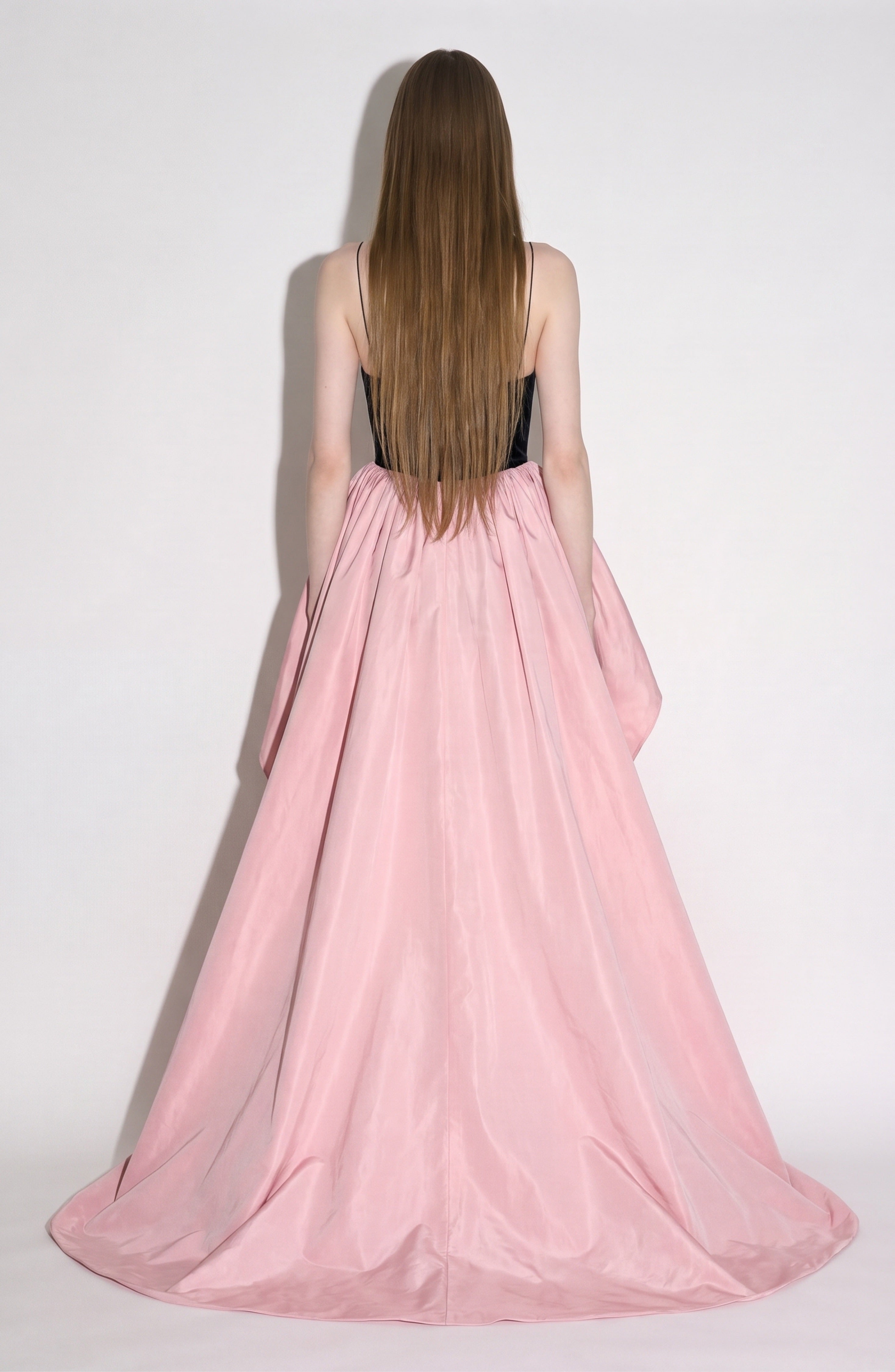 A person with long straight brown hair, wearing the LOULOU Embellished Velvet Mini Dress, stands facing away against a plain light background.