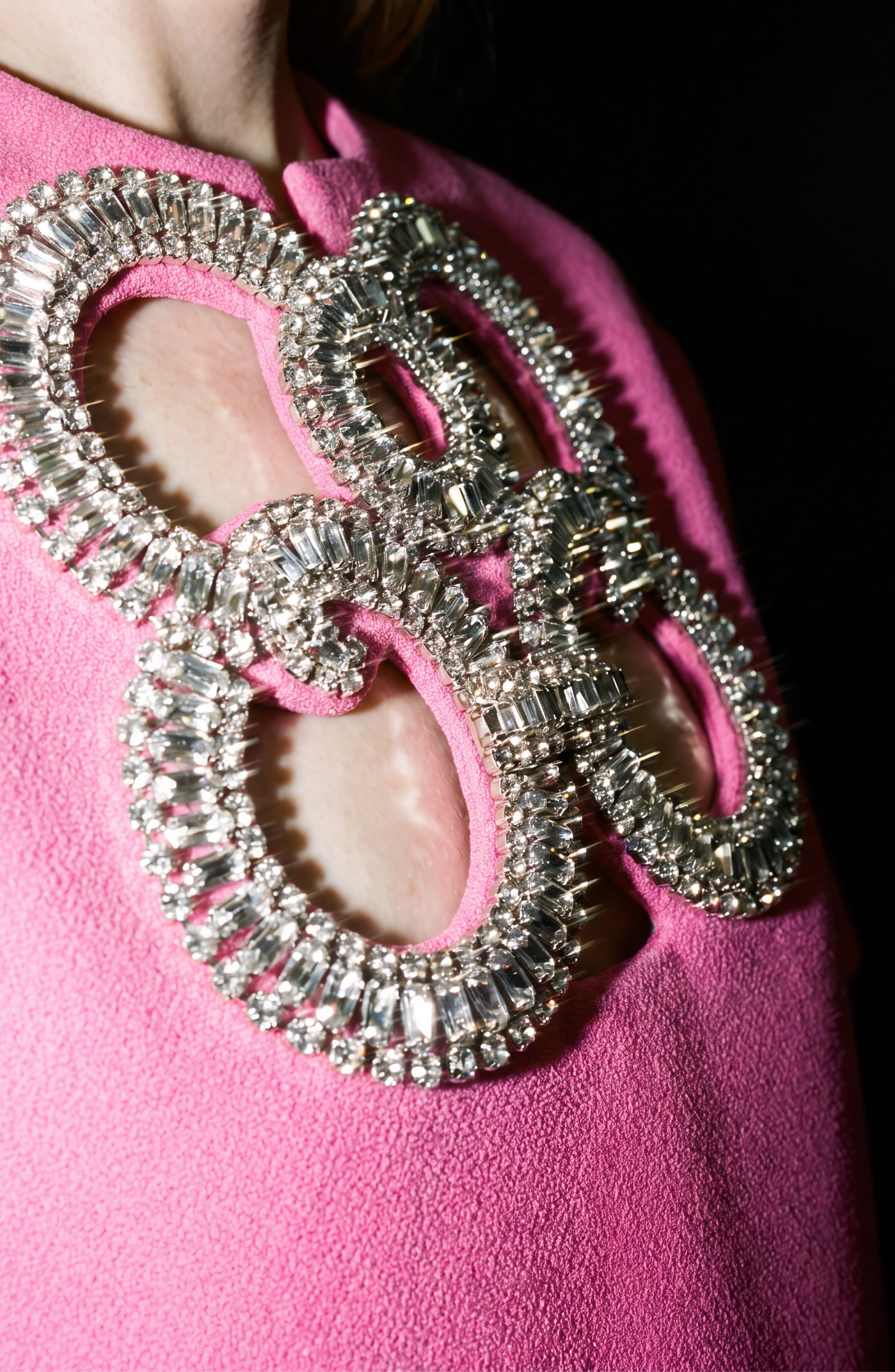 A close-up of the LOULOU Crystal Cutout Mini Dress featuring large, overlapping oval cutouts outlined with sparkling, jewel-like silver embellishments that reveal glimpses of skin beneath—perfectly embodying the allure of a crystal embellished dress.