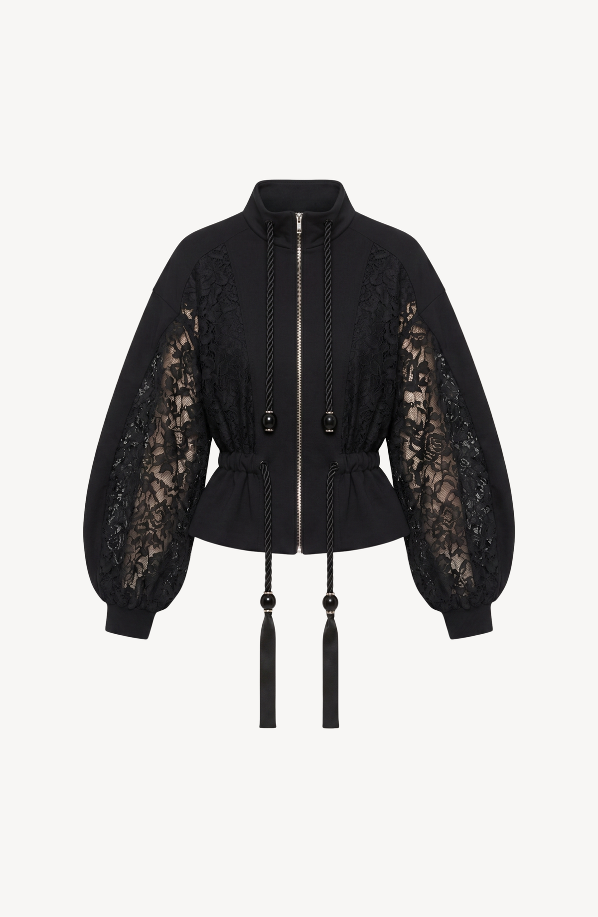 The After Hours Bomber by LOULOU is a black cotton jacket with sheer floral-lace sleeves, a cinched waist, and long tasseled drawstrings at the collar.