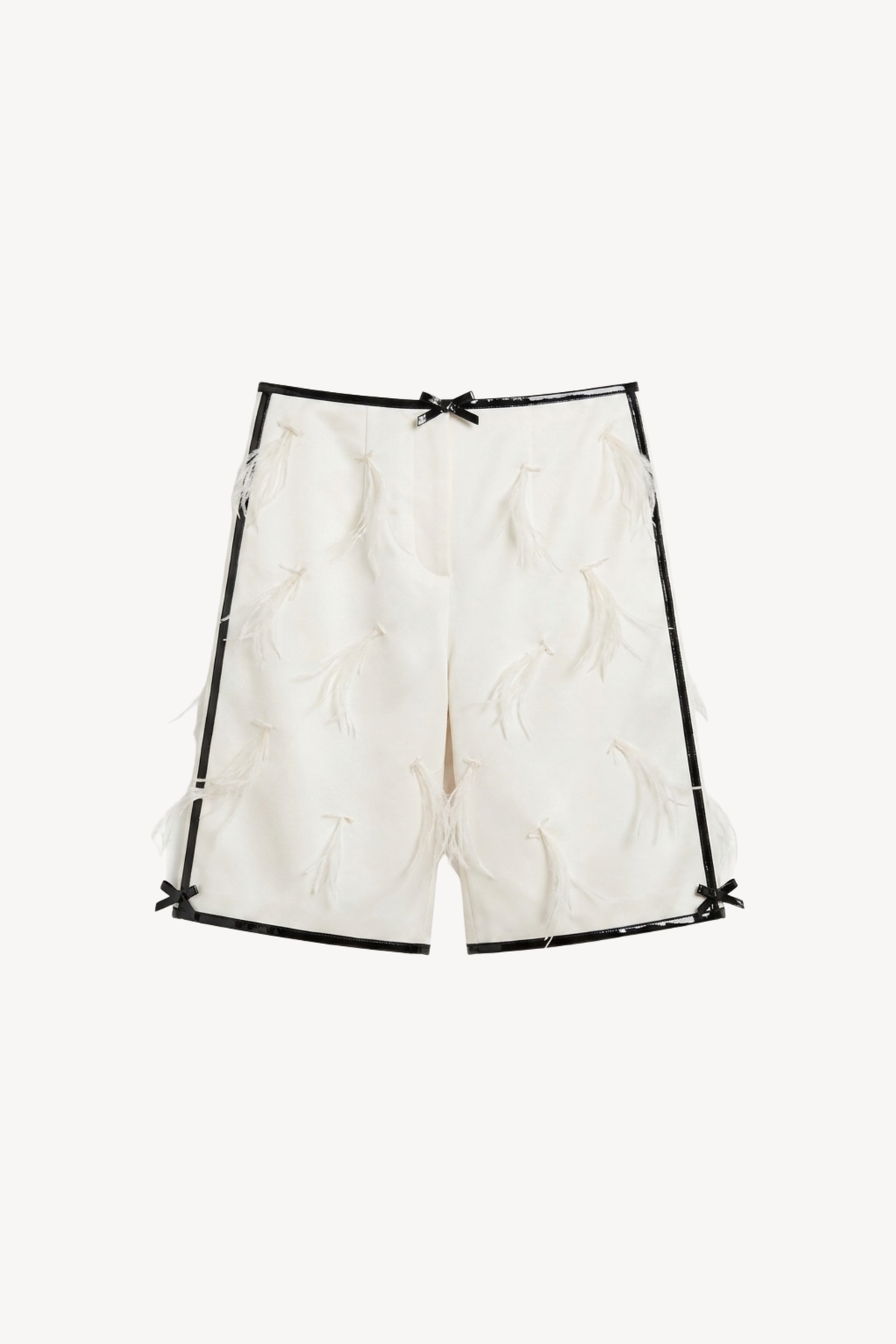 LOULOU Applique Bermuda Shorts in ivory, detailed with black trim, small decorative bows, and scattered feather appliqués, shown against a plain white background.