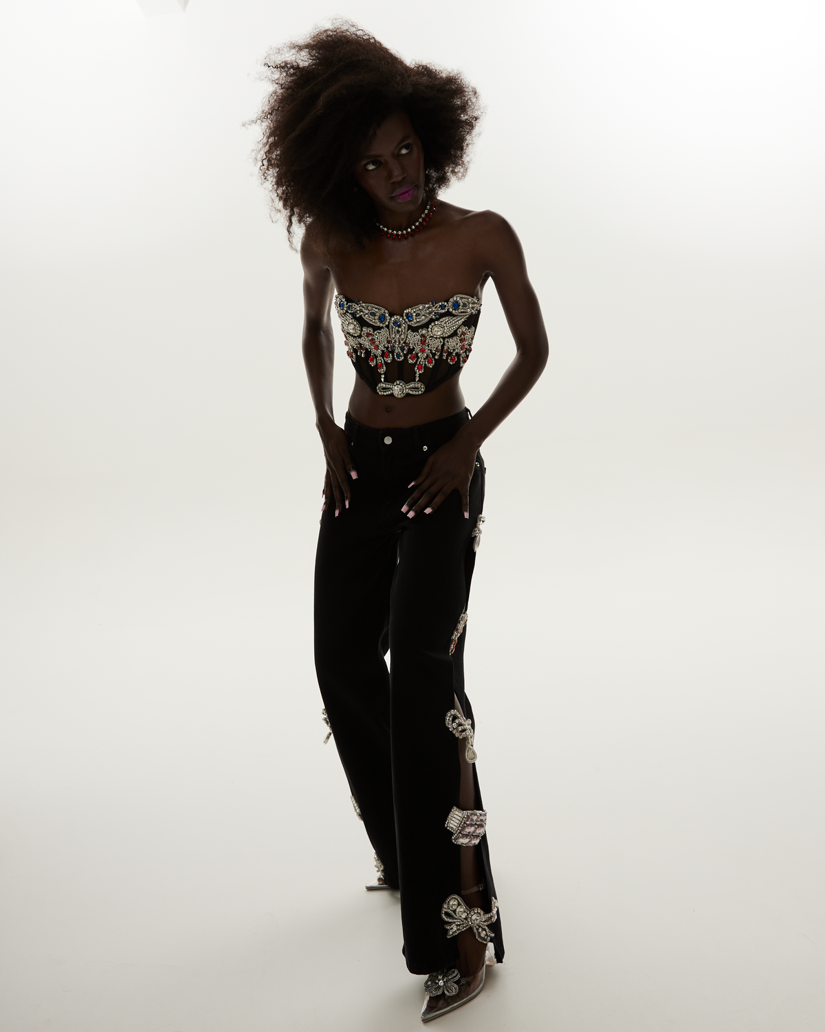 LOULOU Black Cut-Out Crystal Denim Jeans styled on model with crystal embellishment and high-waisted black denim silhouette.