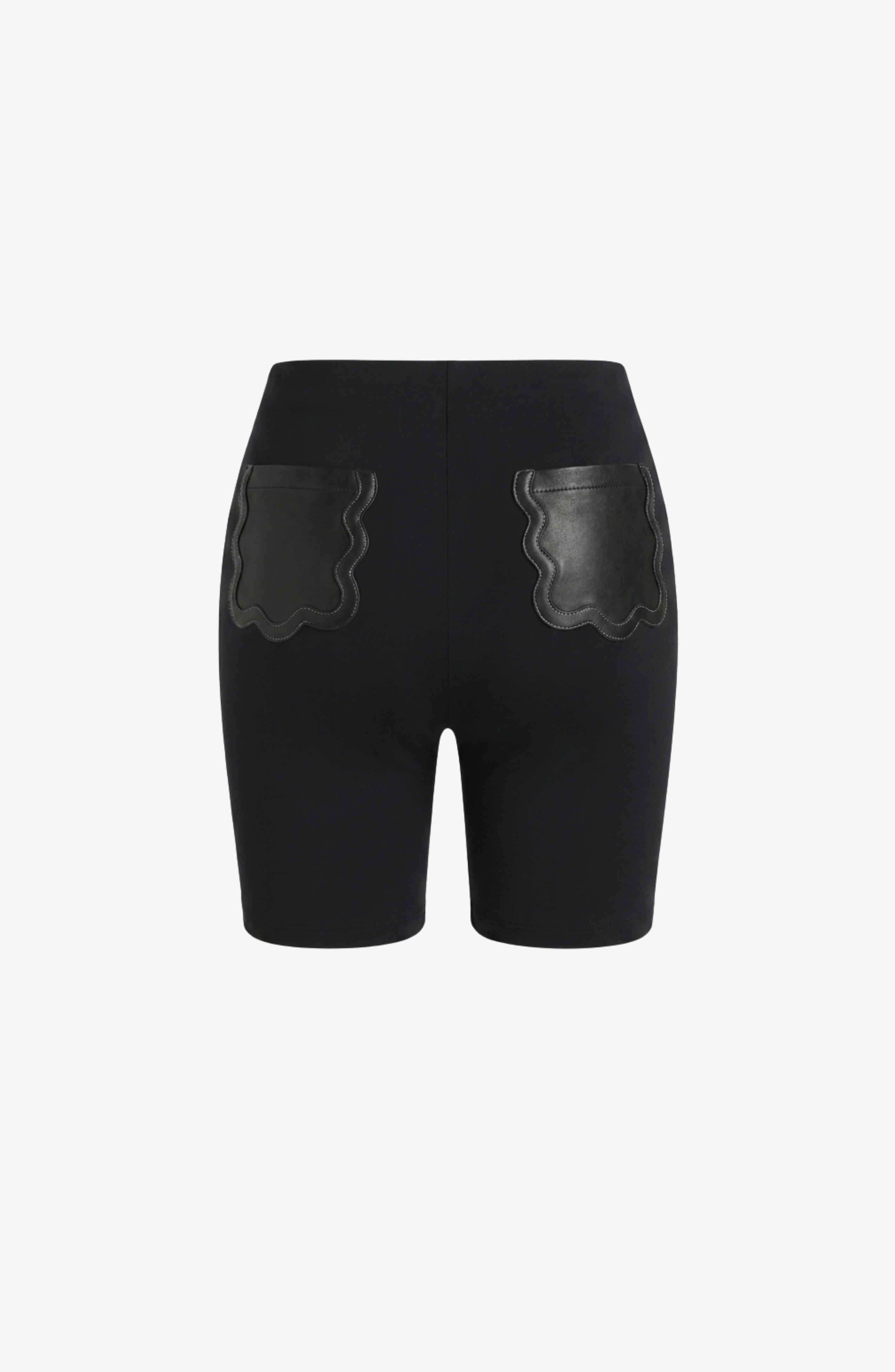 The LOULOU Scalloped Leather Pocket Shorts are black high-waisted shorts made from stretch jersey, featuring two scalloped leather patch pockets on the back, and are displayed against a plain white background.